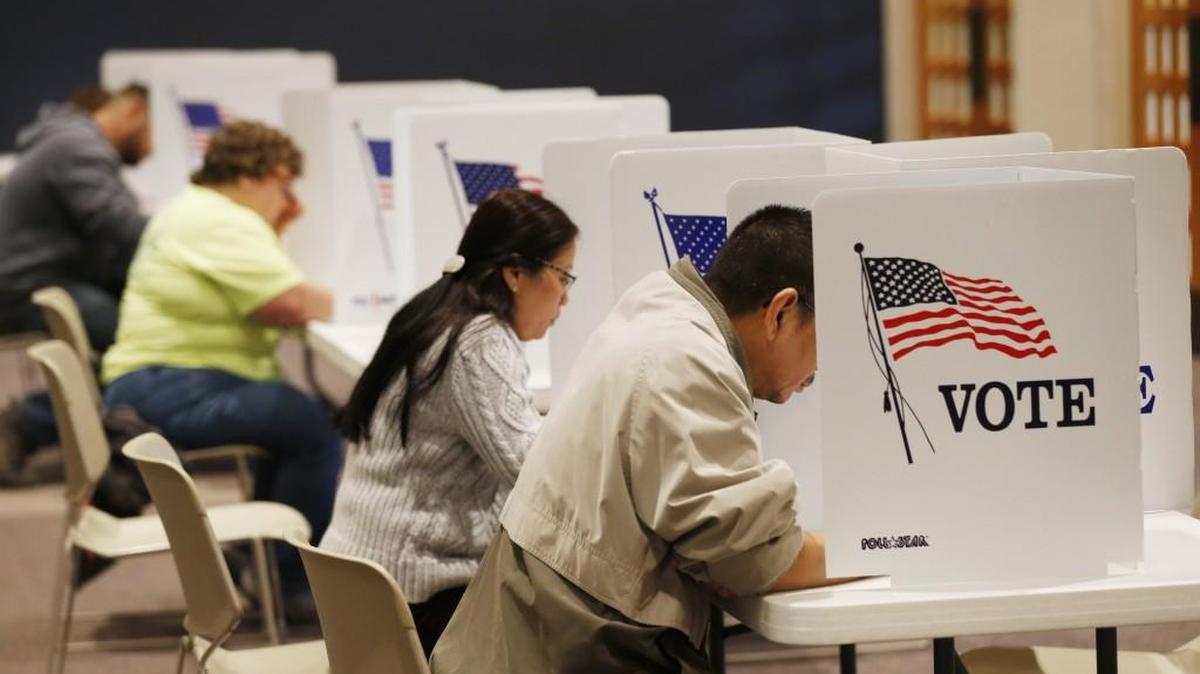 Voters fill out paper ballots at First Mennonite Brethren church last November. Tuesday is the last day to register before city and school elections Nov. 7.