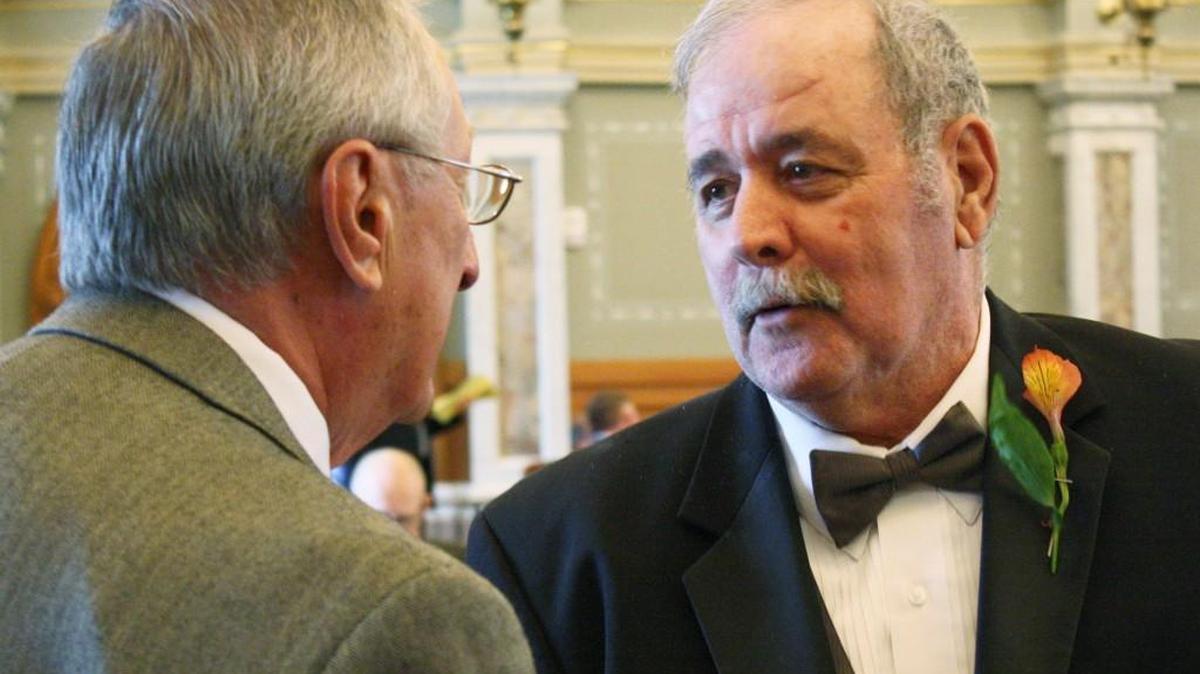 Rep. Bob Grant, right, talks to Rep. Richard Proehl on the Kansas House floor in 2013. The date for naming a buffalo herd after Grant, who died in December, has raised the ire of Senate Democrats.