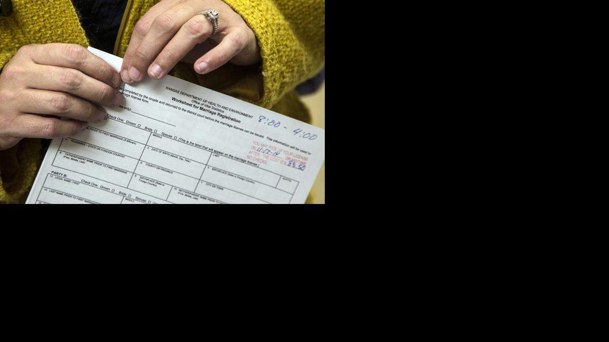 
Residents pick up applications for marriage licenses at the Sedgwick County Courthouse after the Supreme Court lifted the hold on same-sex marriage in Kansas. (Nov.13, 2014)
