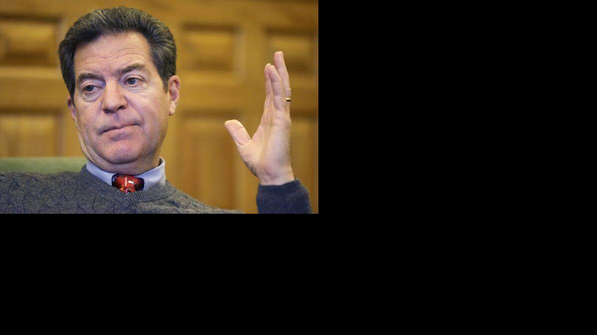 
Kansas Gov. Sam Brownback responds to a reporter’s question at his office in the Statehouse in Topeka on Wednesday, Dec. 10, 2014. 
