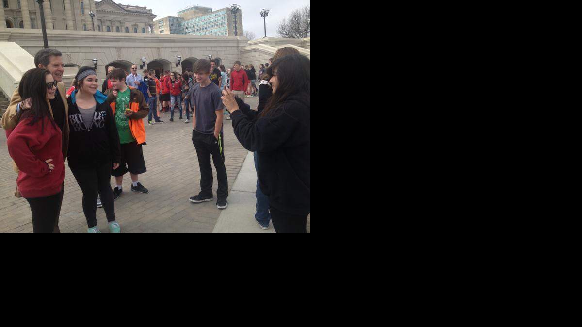 
Gov. Sam Brownback, left, greets students from the McPherson school district who were visiting the Capitol on a field trip Wednesday, the same day he signed the block-grant bill changing the state’s school funding formula.
