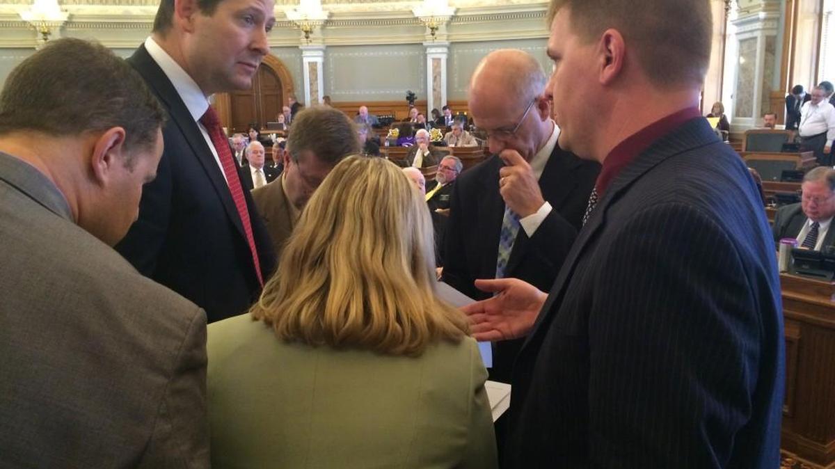 Rep. Ron Ryckman, R-Olathe, House Appropriations chair, (second from left) confers with state budget director Shawn Sullivan (right) during Wednesday's House budget debate.