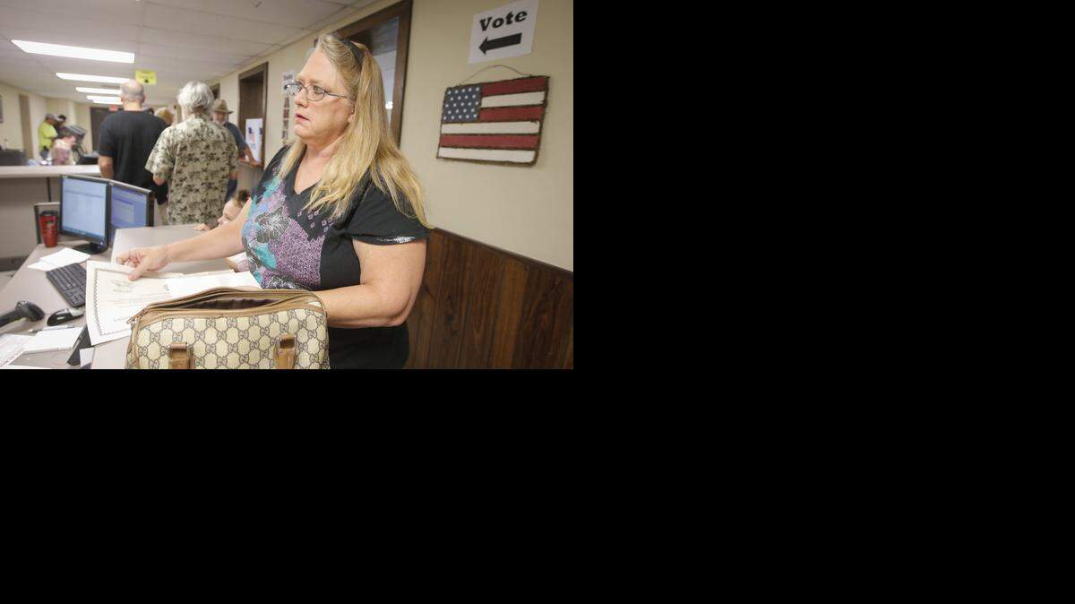 
De Anna Allen provides documents at the Old Sedgwick County Courthouse to have her name removed from a list of suspended voters. Allen was one of thousands of Kansans on the suspended voters list because she has not provided proof of citizenship.
