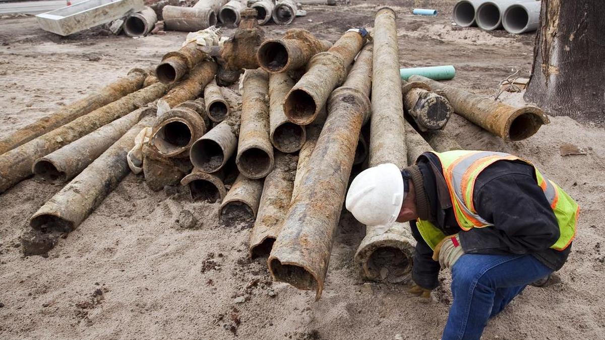 Duane Boutz, a supervisor with Dondlinger & Sons Construction Co., inspects a leaded joint in an old and corroded water line that was removed along 13th Street. Increases in water usage bills will help pay for repairs and infrastructure needs. (Feb. 7, 2013)