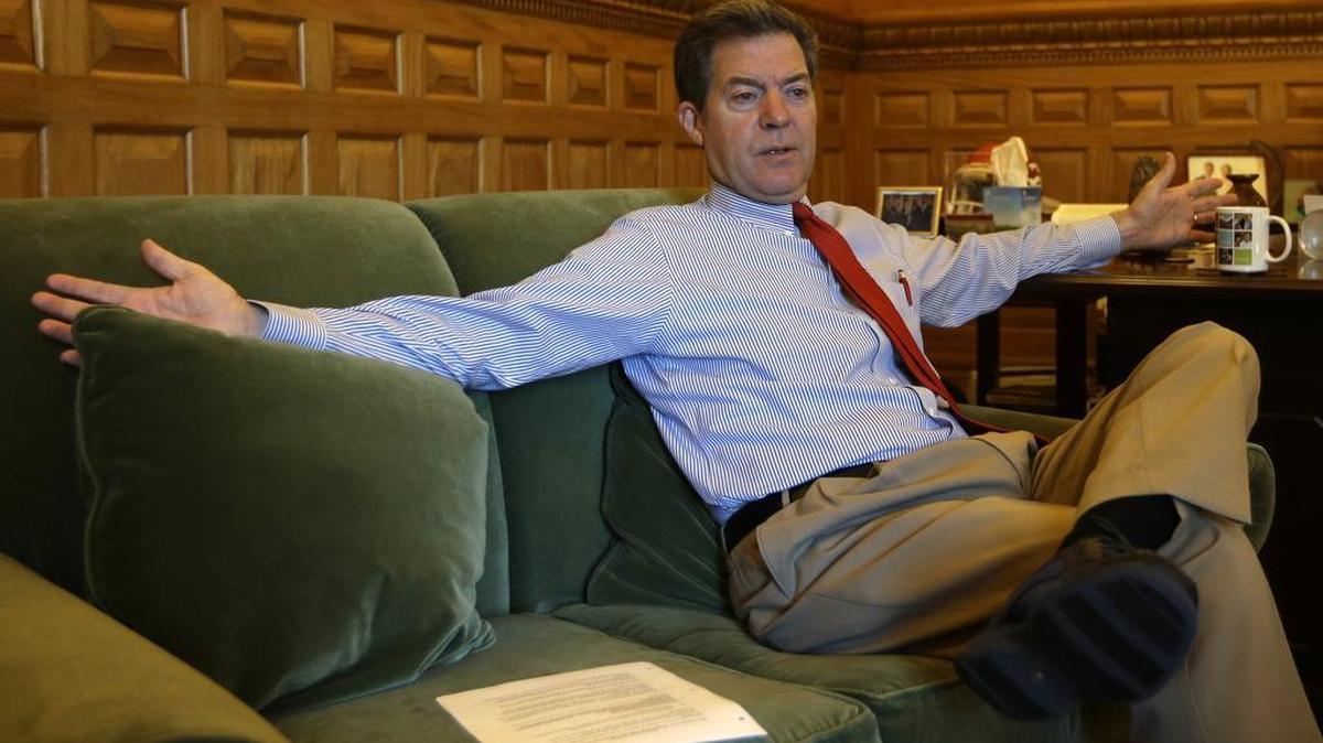 
Gov. Sam Brownback responds to a reporter’s question during an interview in his Statehouse office in Topeka on Friday. (Sept. 11, 2015)
