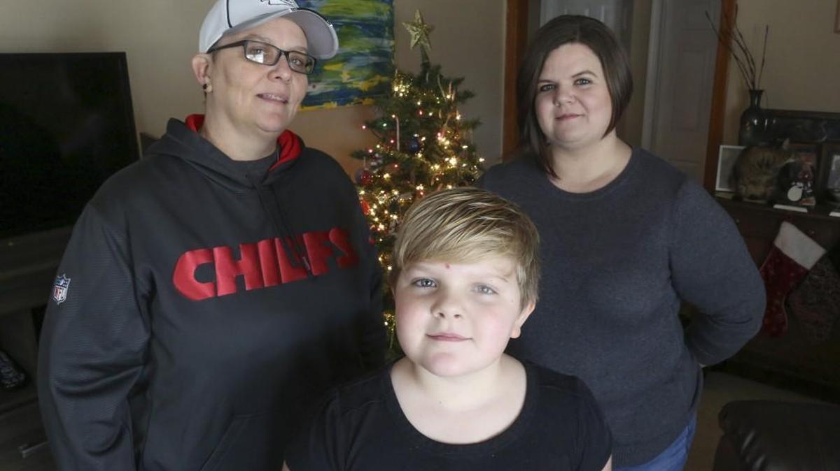 Krista Casmaer, left, along with Mindy Kufahl, right, and Kufahl’s daughter Phoebe Edgerton-Kufahl, who was not the child at the center of their foster parenting case, are two of several gays and lesbians who say that the Kansas Department for Children and Families has discriminated against them in adoption and foster care cases.