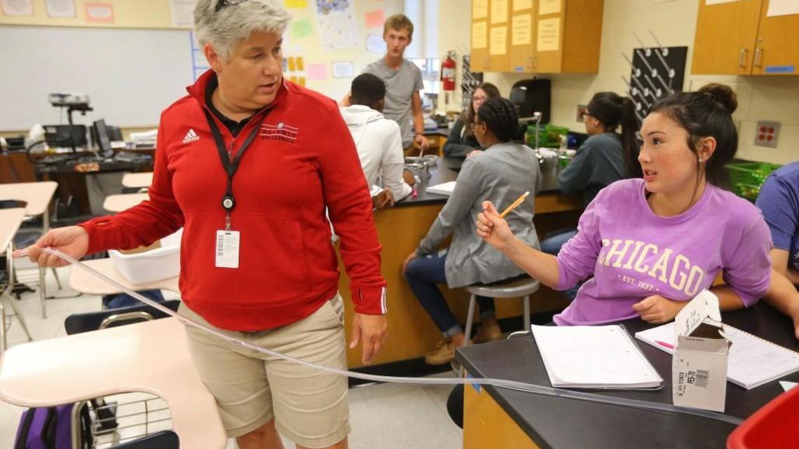 Heights Teacher Shari Hatfield, left, shows Advanced Placement chemistry student Cheyenne Goodman some issues with an experiment earlier this month.