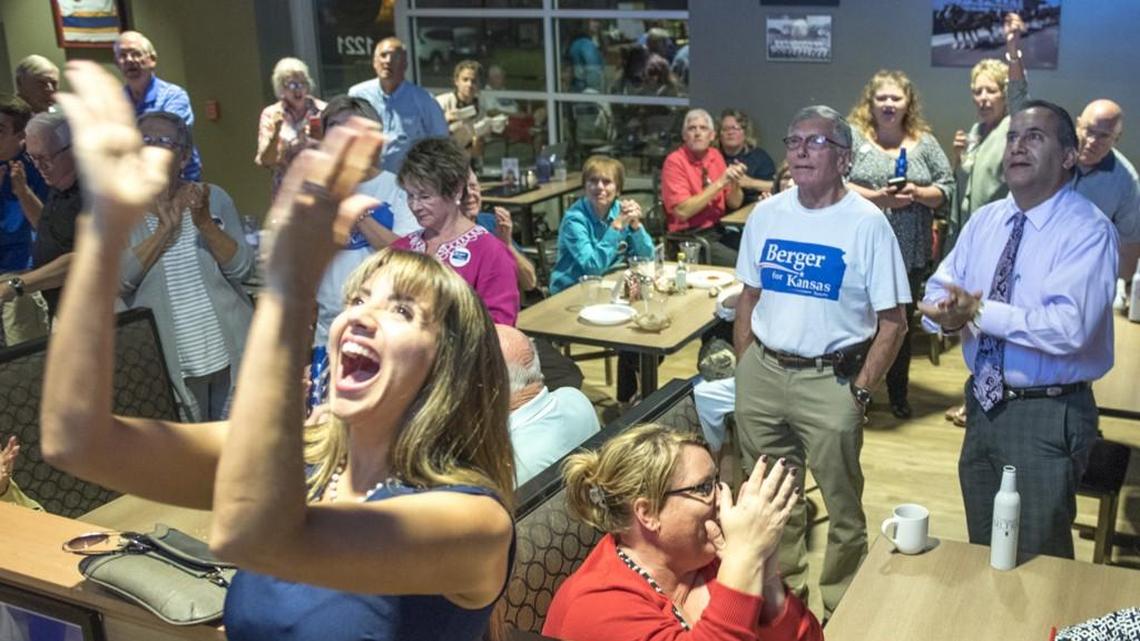 Jade Piros de Carvalho, left, claps enthusiastically as Ed Berger's results appear on the big screen during his election party at AJ's Sports Grill at The Alley on primary election night in August 2016. Berger defeated Terry Bruce, who was then Senate majority leader.