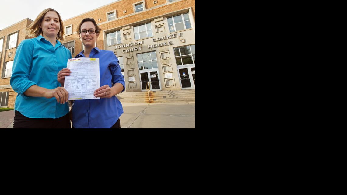 
Angela Schaefer, left, and her partner, Jennifer Schaefer, hold an application for a marriage license at the clerk’s office at the Johnson County Courthouse this week in Olathe. 
