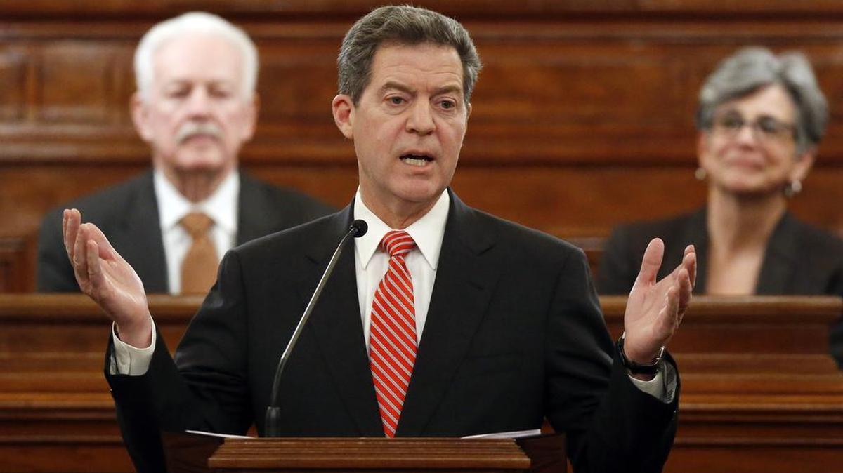 Kansas Gov. Sam Brownback addresses a joint session of the Kansas House and Senate during his annual State of the State address last year. Behind him are Speaker of the House Ray Merrick, left, and Senate President Susan Wagle. (Jan. 15, 2015)