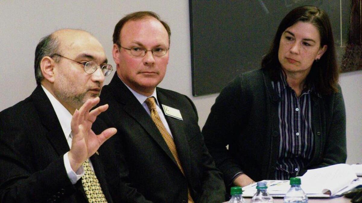 FILE -- Jagadeesh Gokhale of the Cato Institute makes a point on Medicaid expansion as Scott Brunner of the Kansas Health Institute and Kari Bruffett, right, of the Kansas Department of Health and Environment look on in 2012. Brunner was a former strategy team leader at the Kansas Health Institute. Bruffett plans to resign as secretary of the Kansas Department of Aging and Disability, it was announced Monday.