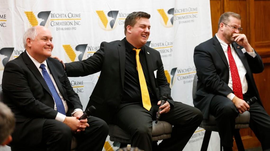 Libertarian candidate Chris Rockhold’s campaign manager, Jordan Husted, center, ribs Republican Ron Estes, left, during the start of a debate Thursday that also included Democrat James Thompson. Thompson, Estes and Rockhold are running for the seat in Congress given up by Mike Pompeo.