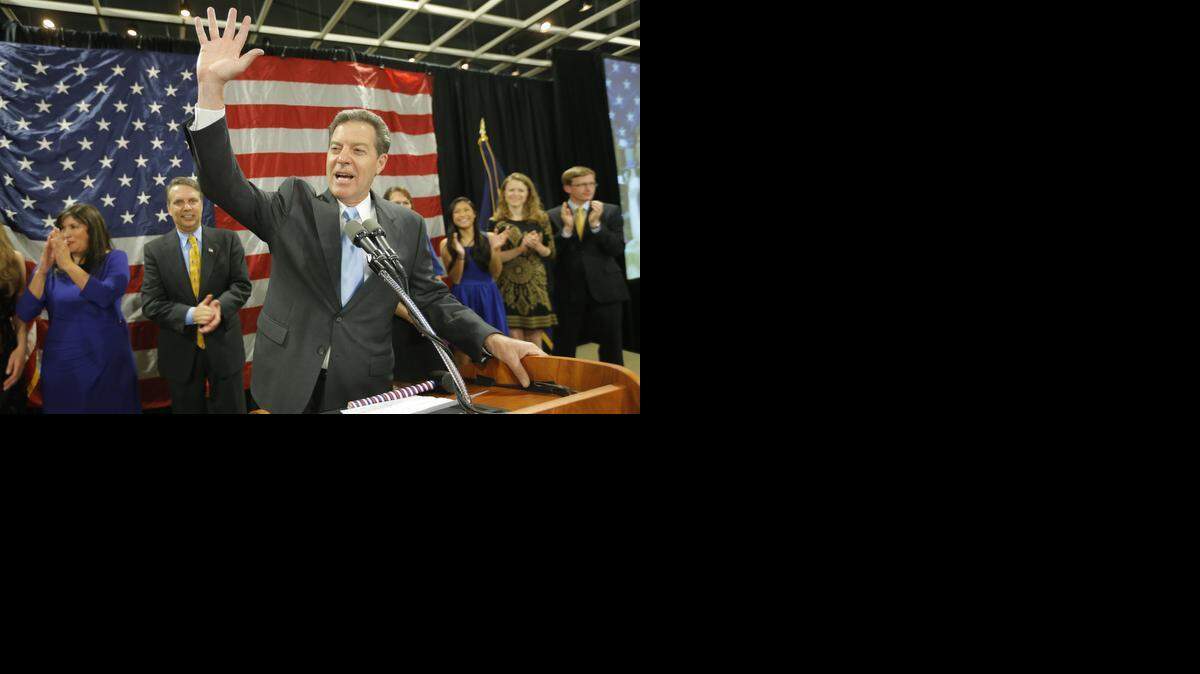
Sam Brownback waves to a cheering crowd in Topeka after he was re-elected governor in November. 
