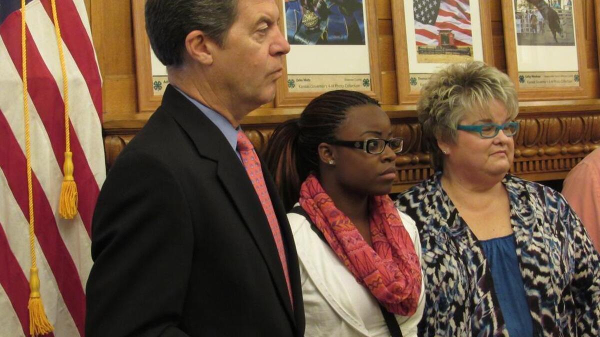 
Gov. Sam Brownback appears Thursday in Topeka with Anna Hockett, a reformed juvenile offender, and Linda Hodgson, her mentor. 
