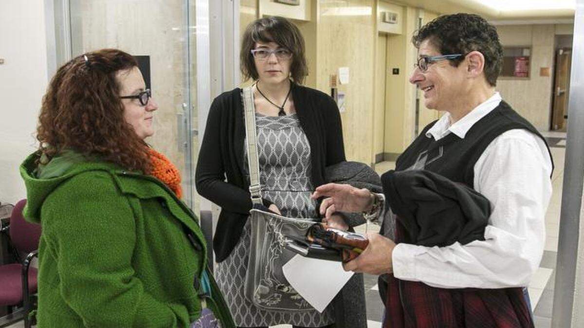 
Shelly Walston, left, and Mallory Rine talk with Jackie Carter, a pastor at First Metropolitan Community Church, at the Sedgwick County Courthouse on Nov. 13.
