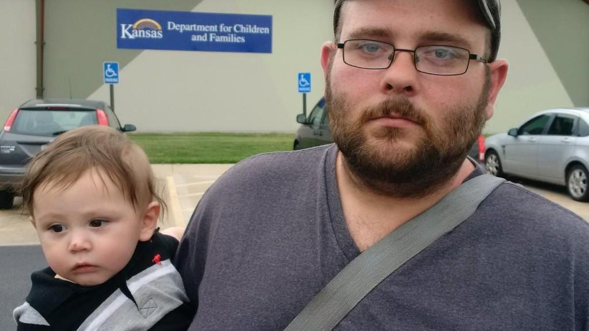 Zach Claassen and son Zach Jr. waited more than five hours for service Monday at the Wichita office of the Department for Children and Families, trying to find out why the family’s food stamps didn’t come.
