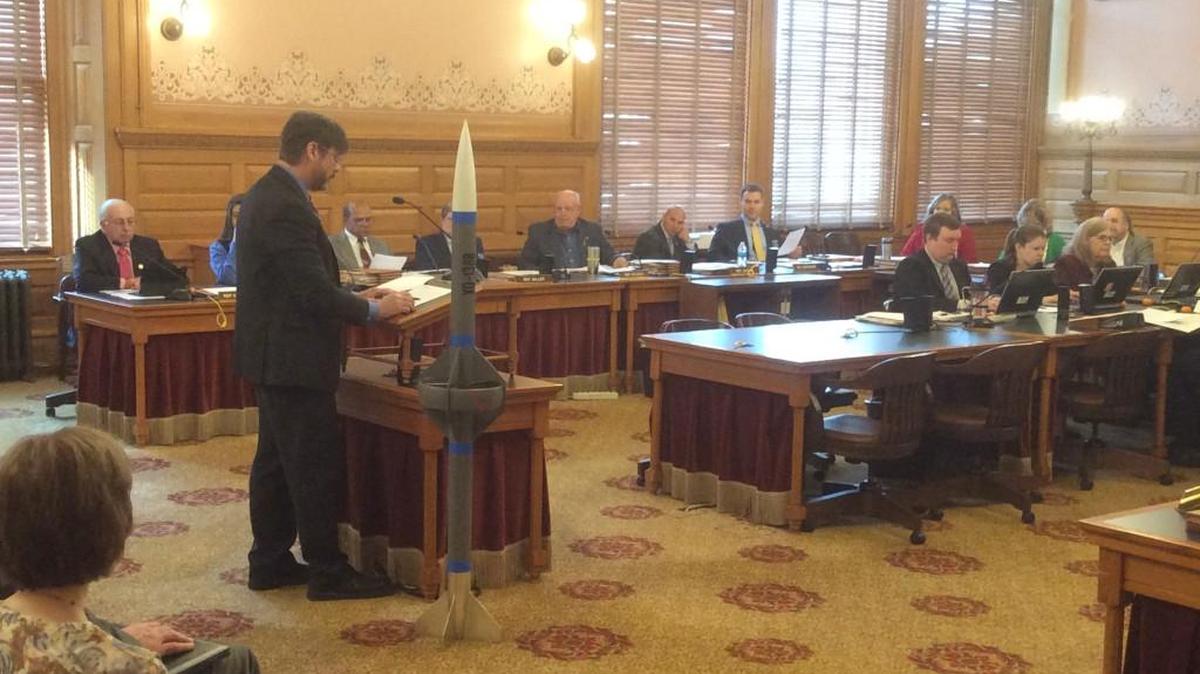 KU professor Ron Barrett-Gonzalez showcases a drone missile during a House Federal and State Affairs Committee hearing Thursday in Topeka. He argued universities should be able to regulate handgun use in areas where projects like the drone missile are tested.