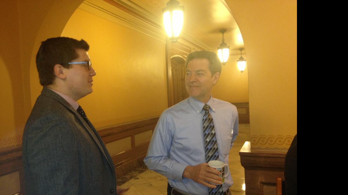 
Gov. Sam Brownback chats with Sen. Jacob LaTurner, R-Pittsburg, at the Capitol Monday. (May 11, 2015)
