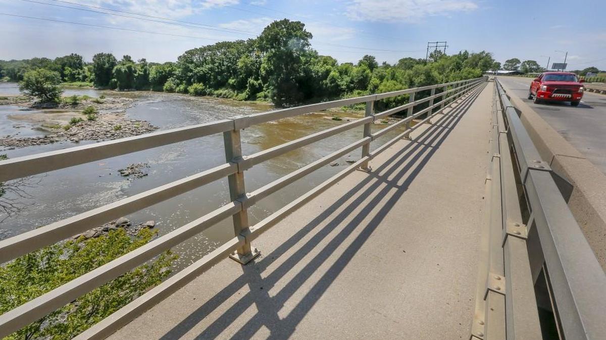 A car crosses the bridge where MacArthur goes over the Arkansas River in south Wichita. (Aug. 4, 2015)