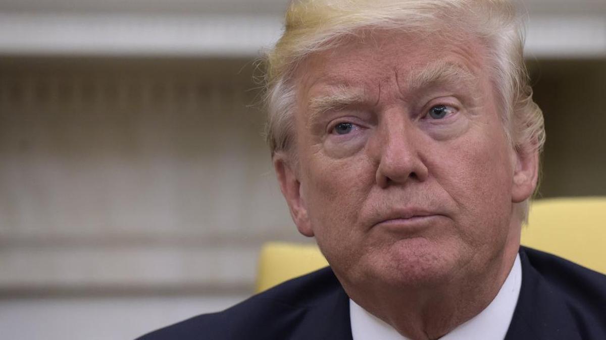President Donald Trump listens in the Oval Office of the White House in Washington on Thursday during his meeting with Colombian President Juan Manuel Santos.