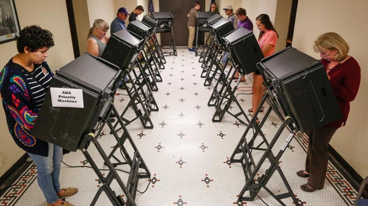 People use electronic voting machines at the Old Sedgwick County Courthouse during early voting in 2016.