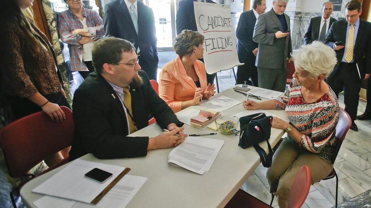 Sue Mollenkamp, right, of Topeka, fills out paperwork to file as a candidate for the Kansas State Board of Education just prior to the filing deadline Wednesday afternoon at the Secretary of State’s Office.