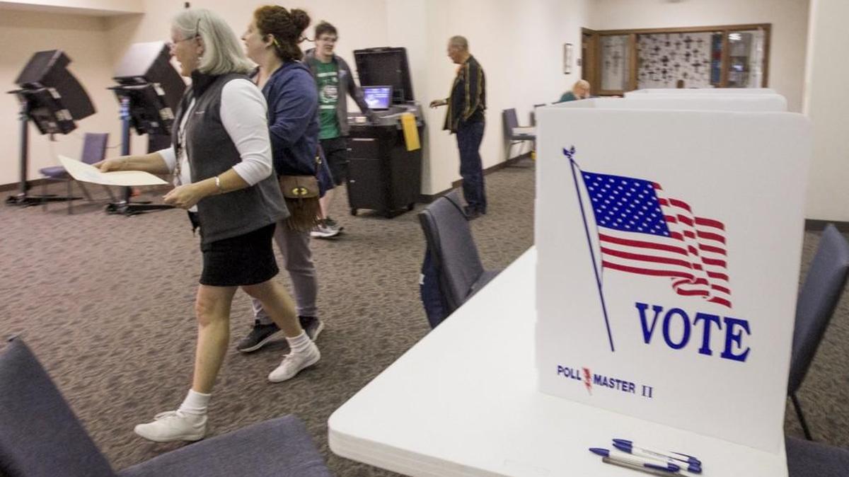Election workers help people through the voting process as they takes advantage of early voting at Grace Presbyterian Church on Nov. 4, 2017.
