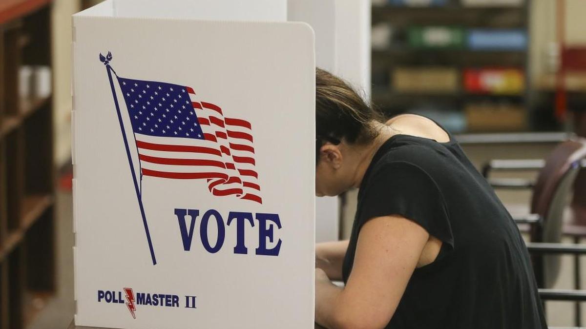 A voter fills out a paper ballot at the Old Sedgwick County Courthouse on Thursday in early voting. Those needing a ride to the polls can call one of several groups offering rides.