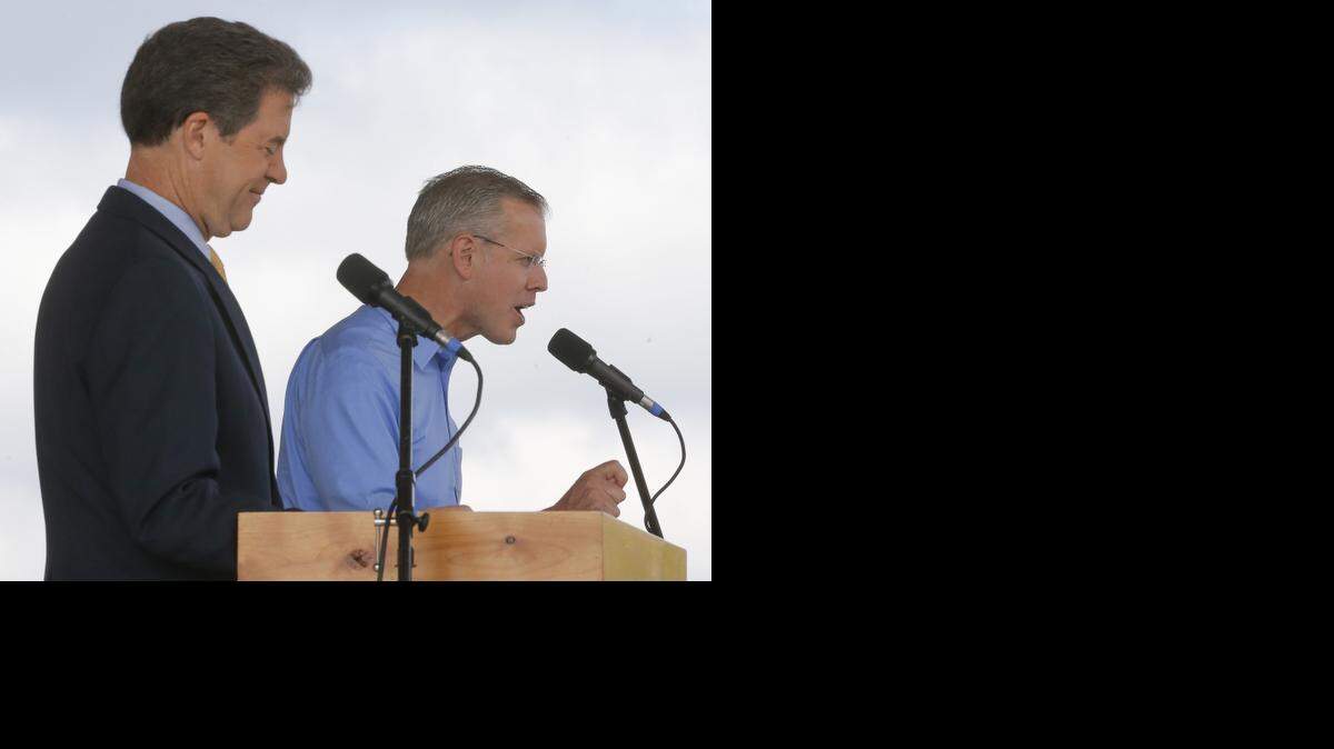 
Democratic challenger Paul Davis speaks and Republican Gov. Sam Brownback listens during their debate on Saturday at the Kansas State Fair in Hutchinson.
