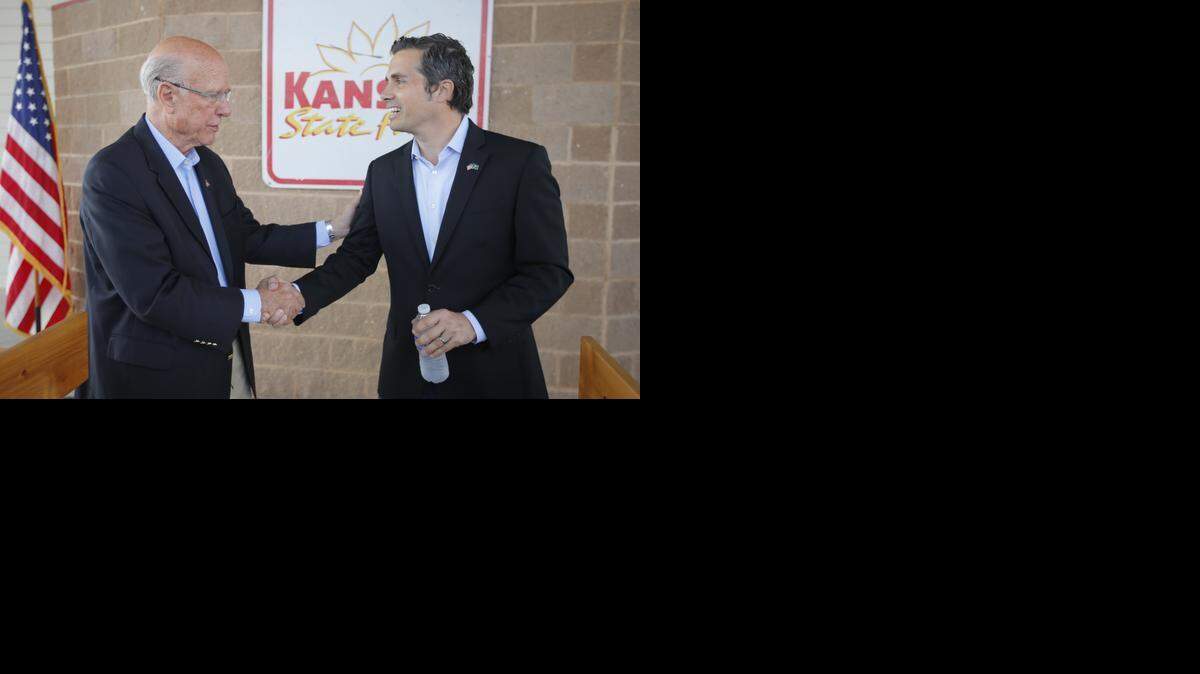 
Sen. Pat Roberts shakes hands with his independent challenger Greg Orman before their debate at the Kansas State Fair in Hutchinson. (Sept. 6, 2014)

