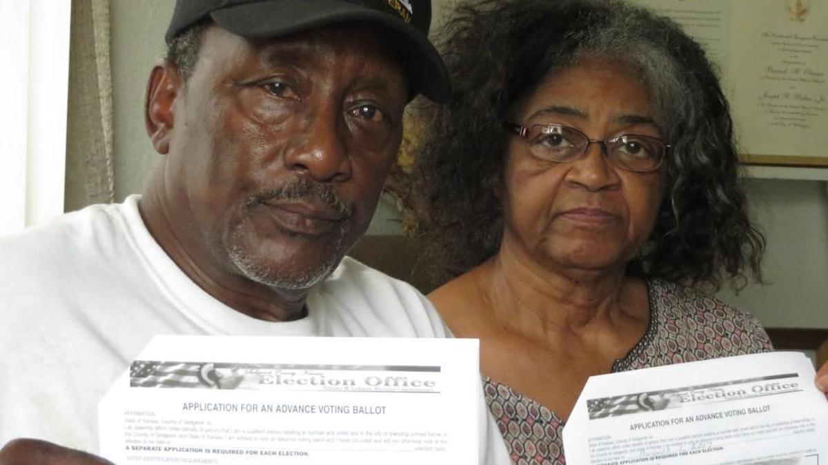 Eugene and Mamie Jewel Anderson hold copies of the mail ballot applications they filed to vote in the Wichita City Council District 1 election. Their ballots were returned to the election office as undeliverable, although the Andersons have lived in the same house for 49 years.