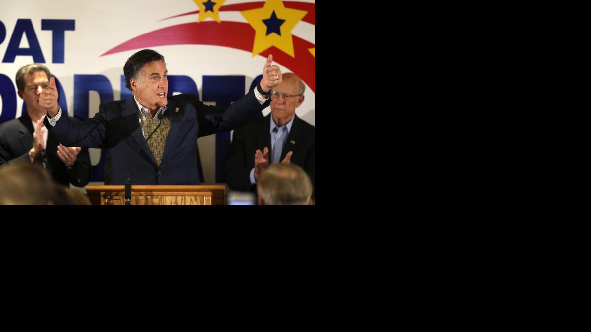 
Mitt Romney gives a thumbs-up while appearing Monday with Gov. Sam Brownback, left, and Sen. Pat Roberts, R-Kan., during a rally for Roberts in Overland Park. Romney is campaigning in Kansas for Roberts’ re-election, portraying a vote for his independent challenger as a vote for Democratic President Obama. 
