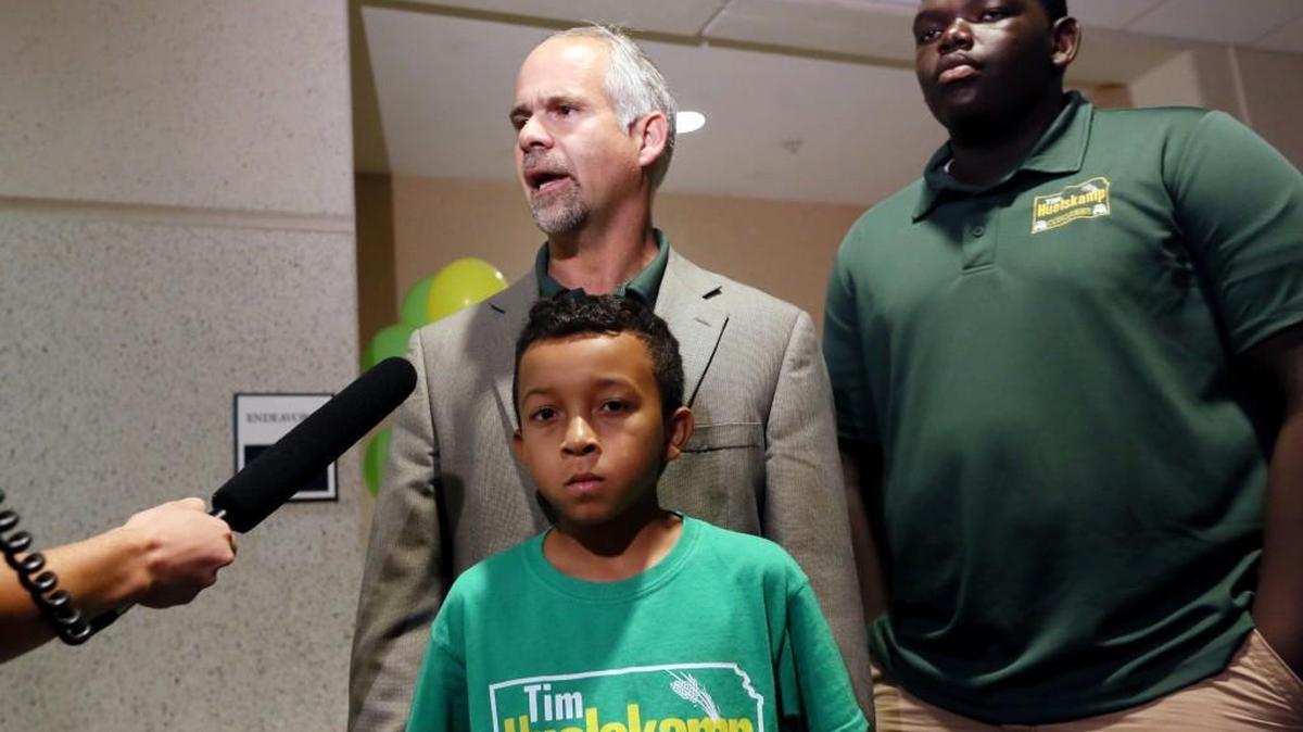 U.S. Rep. Tim Huelskamp answers questions from the media after his primary election watch party Tuesday night in Hutchinson. Pictured with him are his sons Alex and Athan, right.