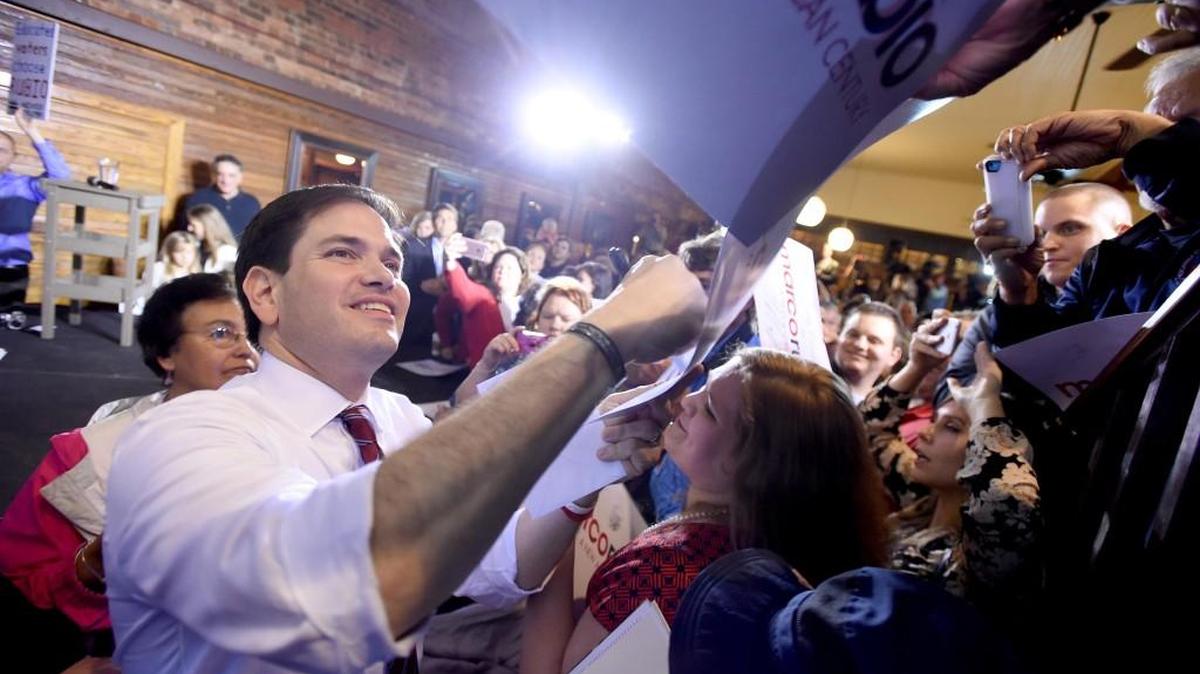 Marco Rubio signs autographs following a rally Saturday at the Palafox Wharf in Pensacola, Fla.