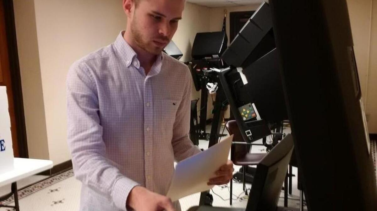 Dalton Glasscock feeds his ballot into the new counting machine at the Sedgwick County election commissioner’s office earlier this week. (March 27, 2017)