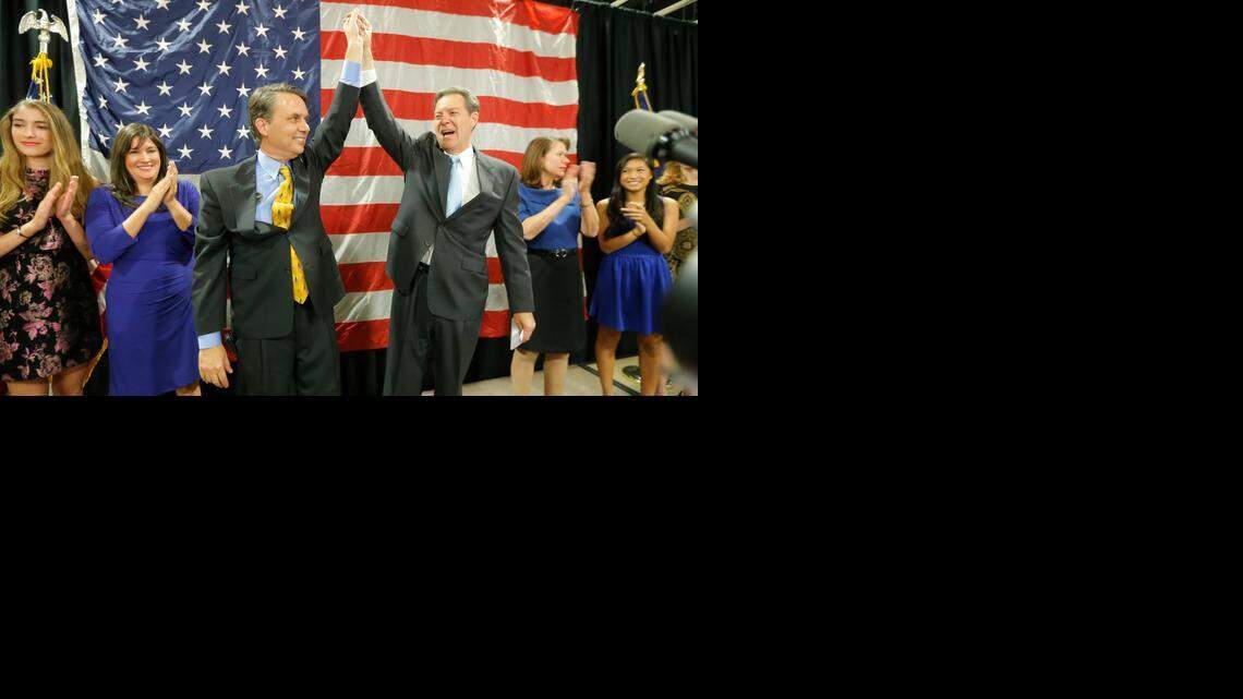 
Sam Brownback and his running mate Jeff Colyer raise their hands to a cheering crowd in Topeka after Brownback was reelected governor in November, 2014.
