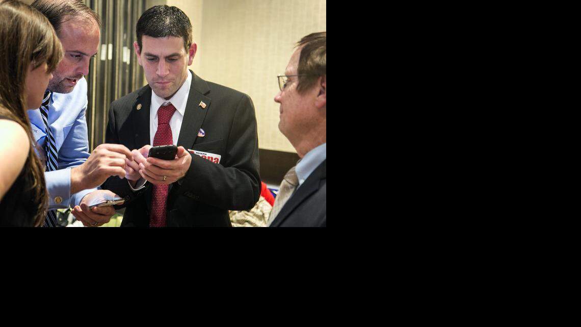 
Representative Joseph Scapa, District 87, checks election results during the Sedgwick County Republican Party election watch party. (Nov. 4, 2014)
