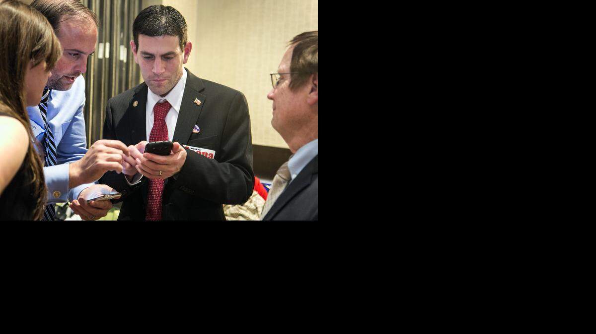 
Representative Joseph Scapa, District 87, checks election results during the Sedgwick County Republican Party election watch party. (Nov. 4, 2014)
