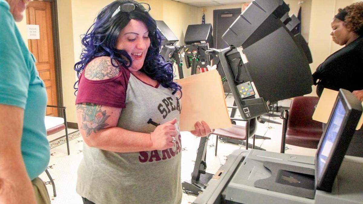 Allison Smith watches her ballot disappear in the final step of early voting in the special election for the 4th District congressional seat at the Historic Sedgwick County Courthouse. (April 5, 2017)