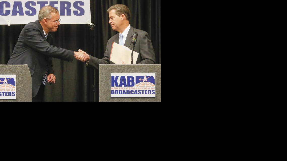 
Kansas gubernatorial candidates Paul Davis, left, and Sam Brownback shake hands following a debate sponsored by the Kansas Association of Broadcasters on Tuesday at the Doubletree Hilton.
