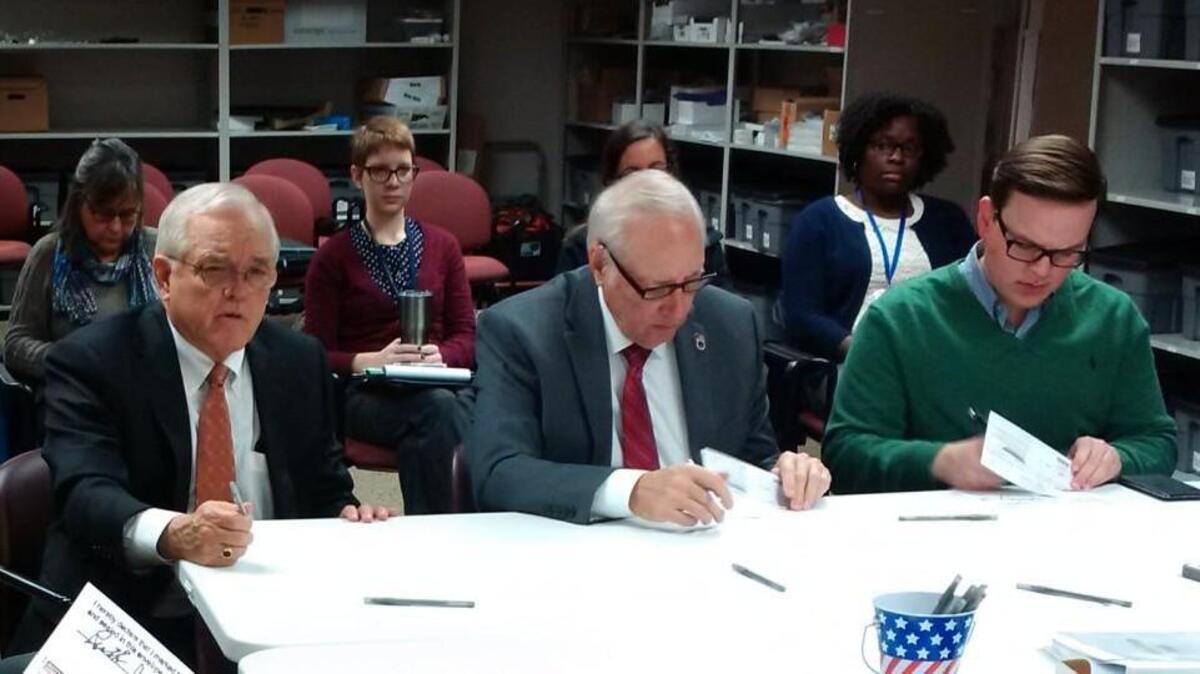 Sedgwick County Commissioners David Unruh, David Dennis and Michael O'Donnell certify ballots during the canvass of votes cast in the Nov. 7 election.