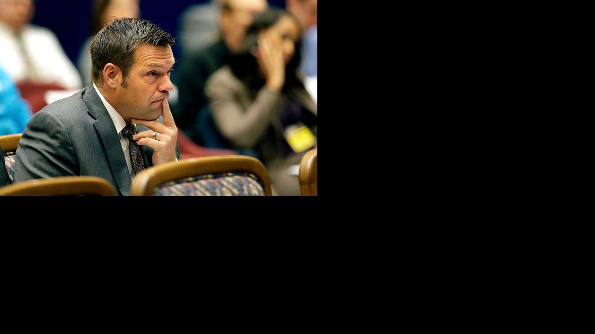 
Kansas Secretary of State Kris Kobach listens to arguments before the Kansas Supreme Court in a petition by Democrat Chad Taylor to remove his name from the ballot after he withdrew from the U.S. Senate race Tuesday, Sept. 16, 2014, in Topeka.
