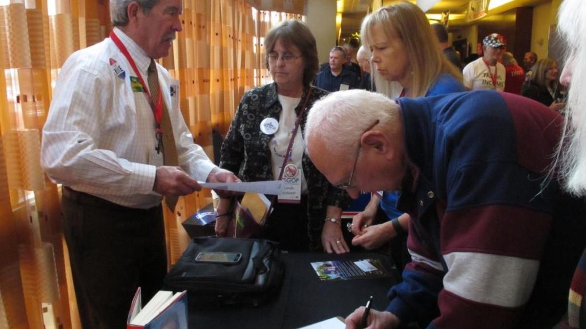 John Pyle, left, a Republican from Hays, talks about candidate Ted Cruz at the GOP convention in Overland Park.