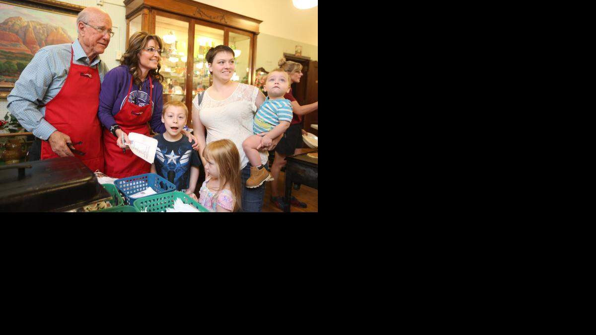 
Ashley Clark and her three children, Liam, Brooklynn and Bronson, take a photograph with former Alaska Gov. Sarah Palin and Sen. Pat Roberts at the Independence Historical Museum and Art Center. Roberts and Palin spoke to a crowd of more than 250 people before serving pancakes and sausage. (Sept. 25, 2014) 
