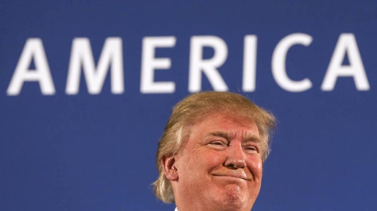 Republican presidential nominee Donald Trump receives applause after speaking at a town hall meeting in New Hampshire.