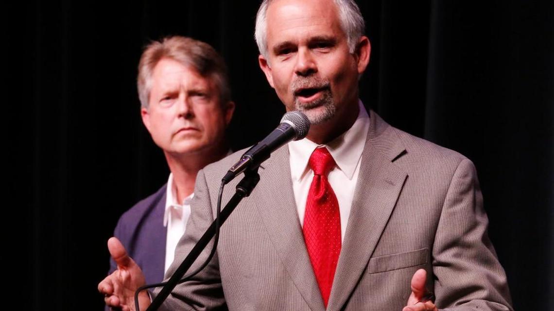 U.S. Rep. Tim Huelskamp responds to a question during a debate Monday night in Hutchinson. His GOP challenger, Roger Marshall, is in the background. (June 27, 2016)