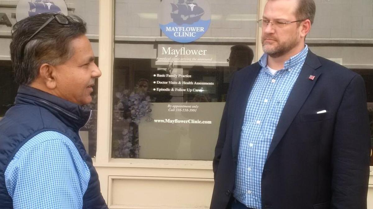 Abdul Arif, left, of the Mayflower Clinic speaks with congressional candidate James Thompson.