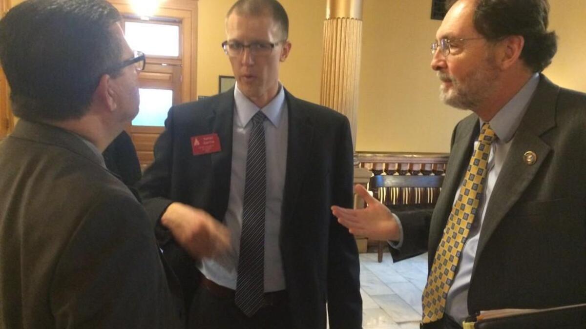 Sedgwick County Commissioners Jim Howell, left, and Karl Peterjohn argue with Nathan Eberline, center, an attorney with the Kansas Association of Counties, about a bill that would restrict local governments from raising property taxes starting in July 2016. (March 8, 2016)
