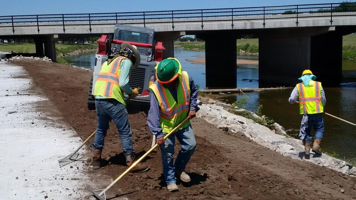 Workers putting final touches on reconstructed Pawnee Street Bridge project Friday.