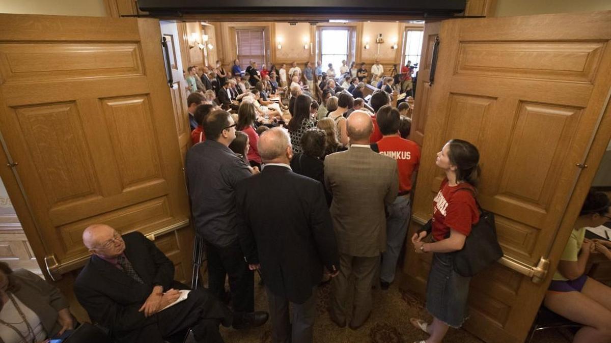 Teachers, school officials, parents and others crowd the doorway of the Old Supreme Court Chambers as a joint meeting of the House and Senate budget committees gets underway to address the issue of school finance funding on Thursday in Topeka.